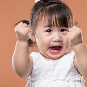Excited Baby Girl Holding Arm Fist