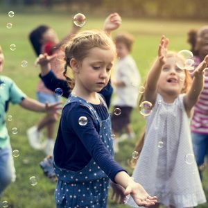 Group Of Kindergarten Kids Friends Playing Blowing Bubbles Fun