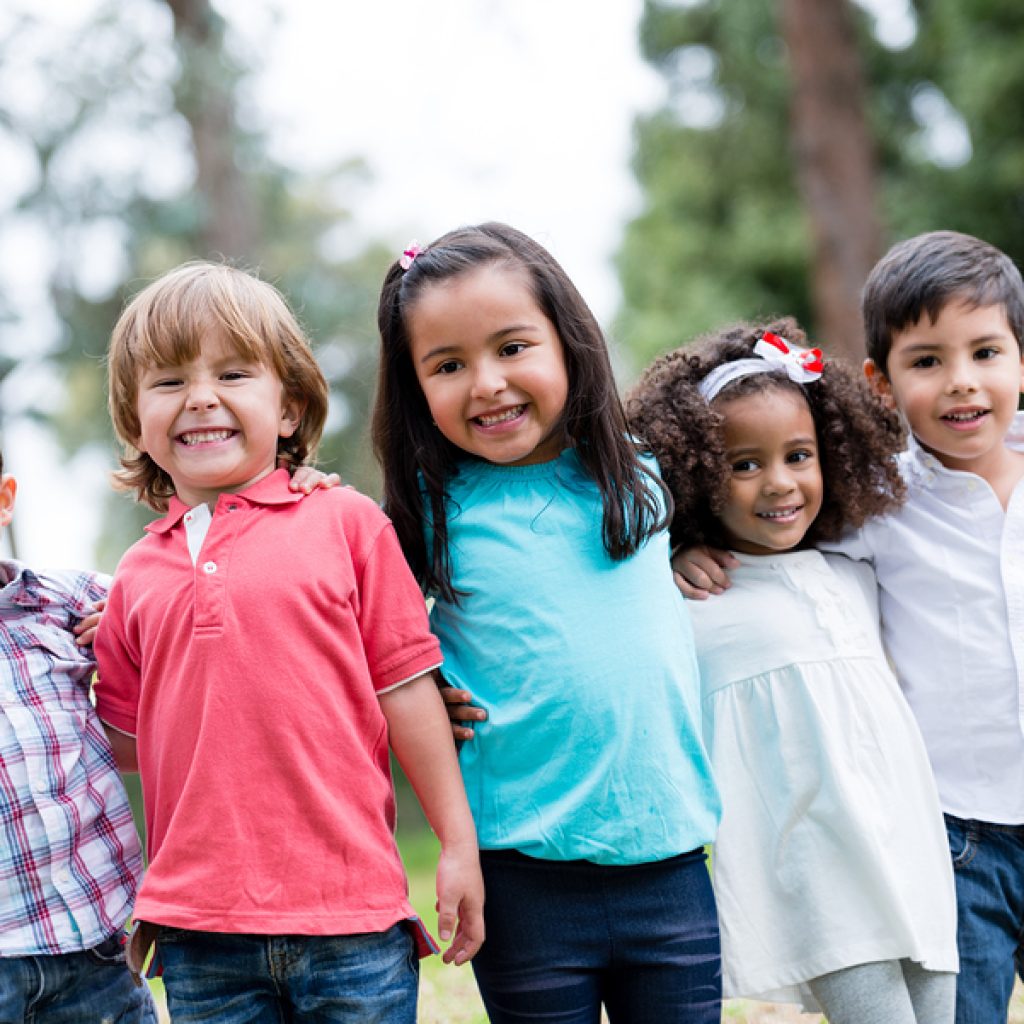Happy Group Of Kids Smiling At The Park