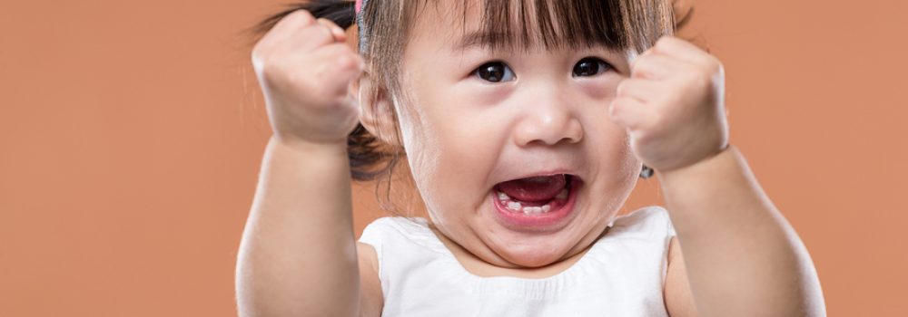 Excited Baby Girl Holding Arm Fist