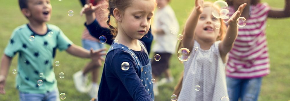 Group Of Kindergarten Kids Friends Playing Blowing Bubbles Fun