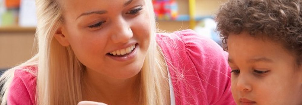 Young woman playing with boy